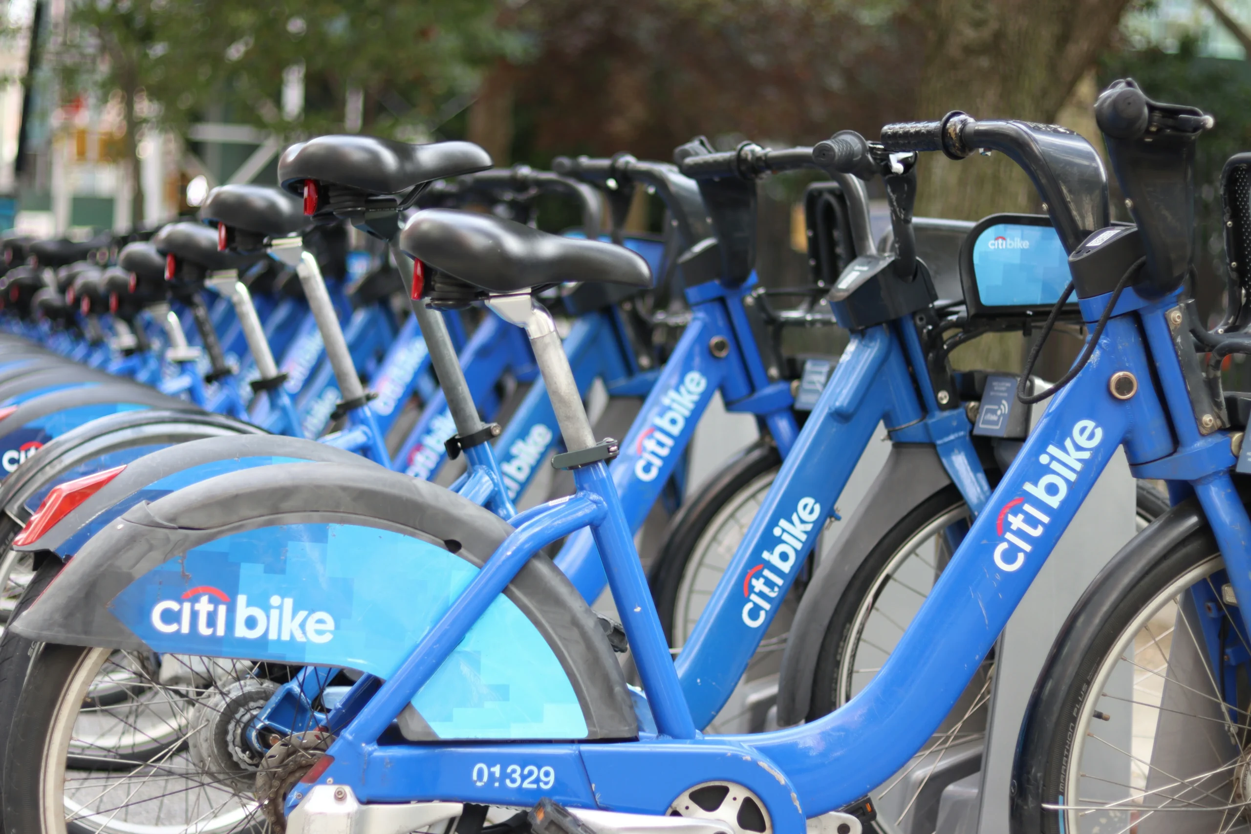 Row of blue Citi Bikes parked at a bike-sharing station.